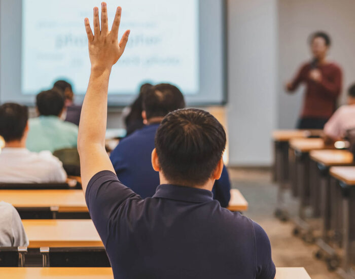 Student raising his hand in class