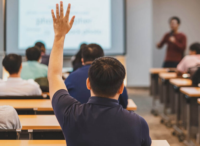Student raising his hand in class