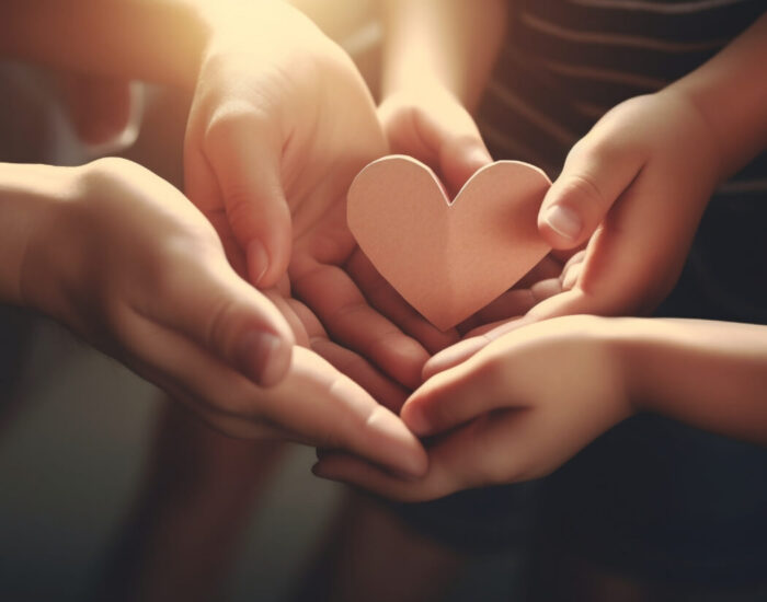 Hands holding a paper heart