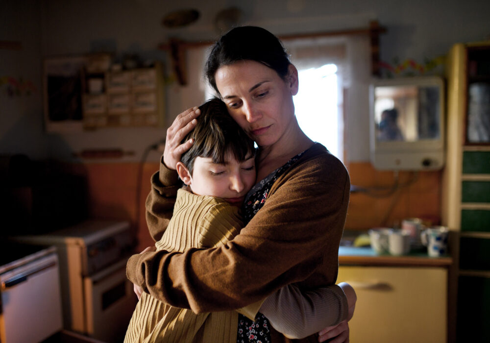 A sad mother hugging her child