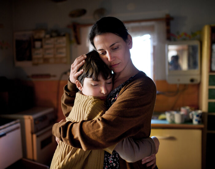 A sad mother hugging her child